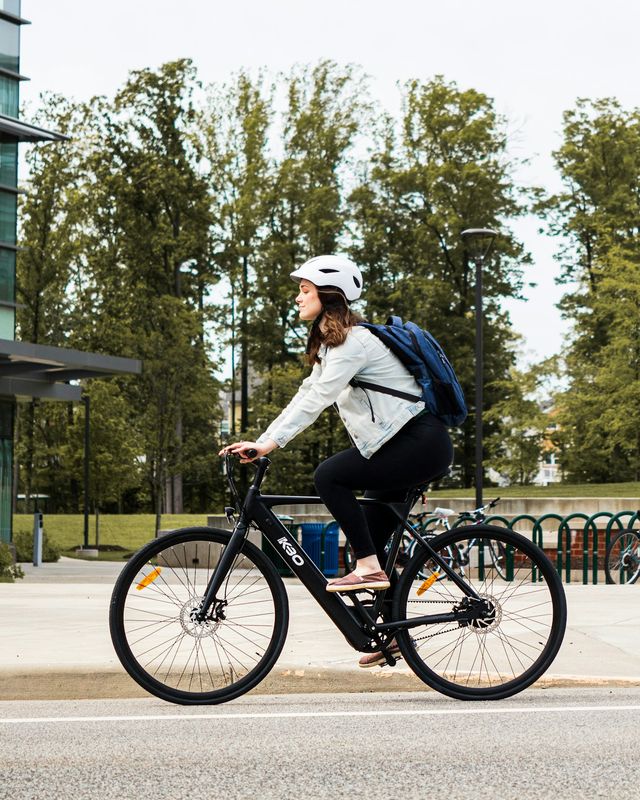 A commuter with a backpack riding through the city